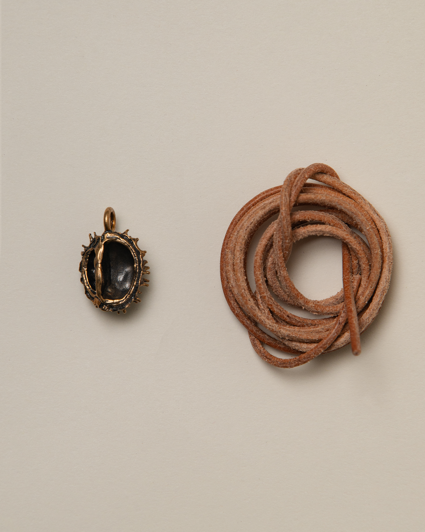 Chestnut pendant, bronze